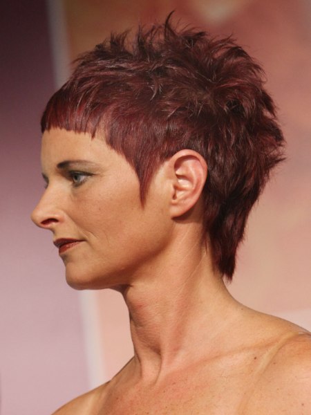 Extravagant short haircut with extra short bangs and pointed sideburns