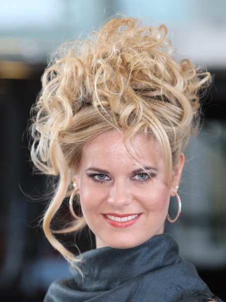 Deliberate messy updo with curls and free spirited tendrils