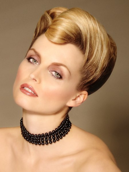 Rockabilly inspired up-style with the hair rolled into a cocks-comb look