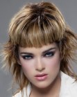 Mid length haircut with a short thick fringe and flared sides