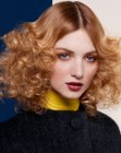 Medium length hair with spiral curls and a sleek top