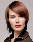 Sleek hair with flipped up ends and eye-skimming bangs