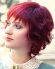 Medium hairstyle with natural curls and frayed bangs