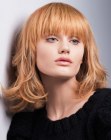 Strawberry blonde shoulder length hair with bangs
