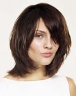 Medium long hairstyle with layers for a brunette