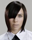 Sleek medium length hair with side-sweeping bangs