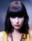 Hairstyle with light spiral curls and blunt bangs