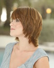 Carefree collar length shag haircut with angled bangs