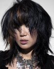 Punky style with heavy bangs for medium length hair