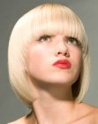 Platinum blonde bob with very straight bangs and tapered sides