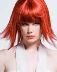 Red hair in a neck-length razored cut with bangs