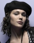 Curly medium length hair worn with a beret hat