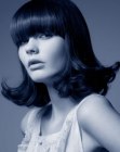 Shoulder length 1960s flip hairstyle with bangs