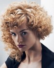 Golden blonde hair with curls and asymmetry