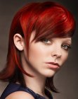 Medium length ruby red hair with a high glam effect