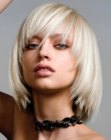 Platinum blonde medium long bob with tapering along the face
