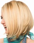 Blonde A-line cut hair with a forward movement