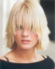 Medium long razor-cut hair with curved bangs