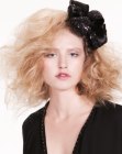 Party hairdo with large curls and a bow