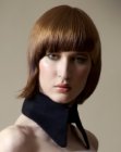 Asymmetrical bob with angled bangs and an S-bend