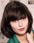 Below the chin bob haircut with heavy bangs