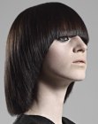 Long back angled bob with a smooth beveled edge