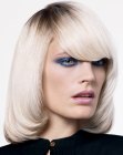 Long blonde bob with tapering along the face
