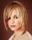 Medium length hairstyle with angled sides and warm hues