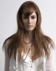 Long light brown hairstyle with pointed bangs