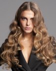 Long dark blonde hair with large waves and curls