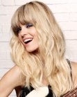 Retro sixties hair with loose waves and round bangs