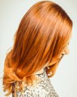 Sleek below the shoulders hair with curled tips