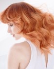 Long wavy hairstyle with highlighted red hair