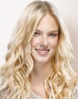 Long blonde hairstyle with loose cork-screw curls