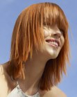 Long tapered bob with bangs for red hair