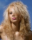 Long blonde hair with tight waves for volume