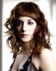 Long hair with wide spiral curls and short arched bangs
