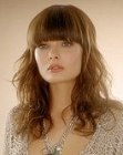Long hairstyle with ruffled waves and eyebrow cuffing bangs