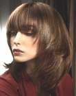 Long hairdo with angled sides and heavy bangs