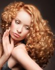 Long red hair with defined spiral curls