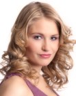 Long blonde hair with defined curls and a natural appeal