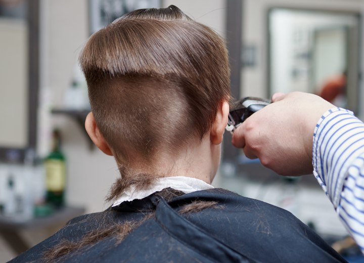 Hairdresser cutting a box fade