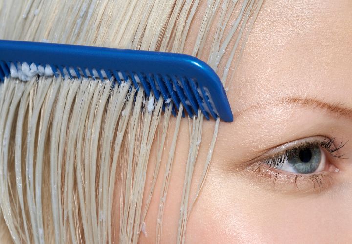 Woman who is combing contioner through her hair