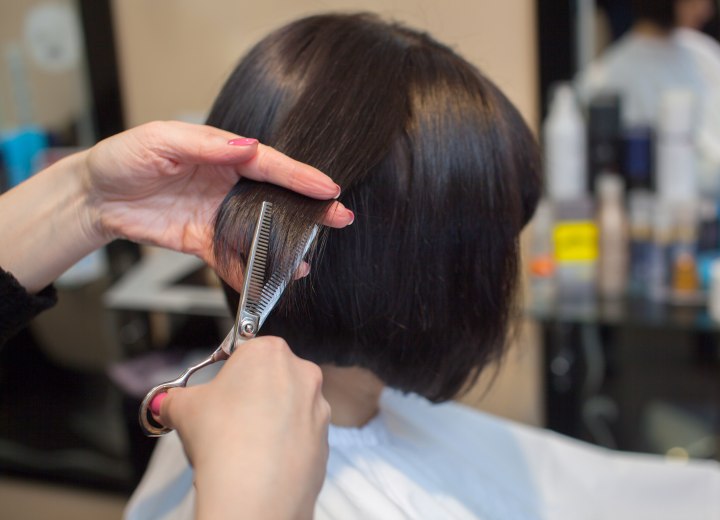 Hairdresser cutting short hair