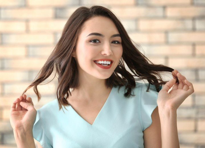 Young woman holding the ends of her hair