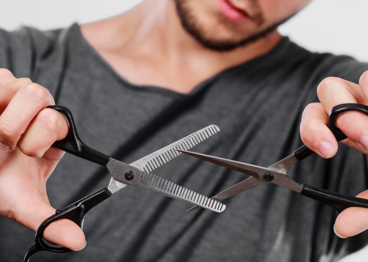 Hairdresser holding hair scissors