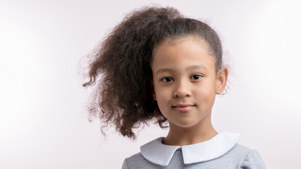 Smoothen mixed race hair on a child with chemical relaxers and hair