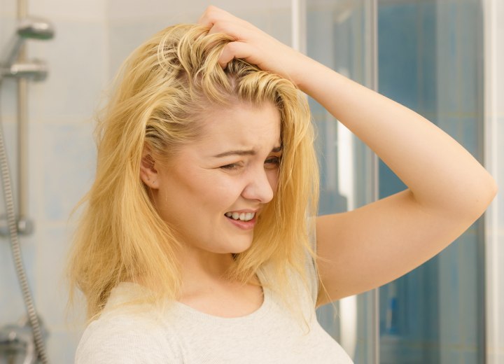 Woman with hair that is oily near the scalp