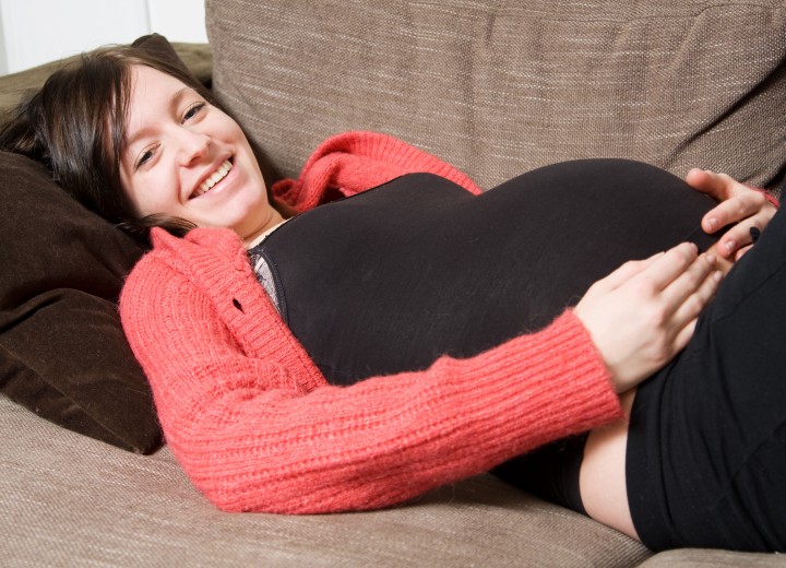 Pregnant woman with colored dark brown hair