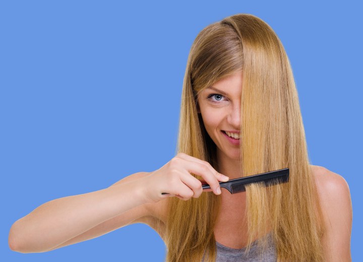 Woman who is combing her long straight hair
